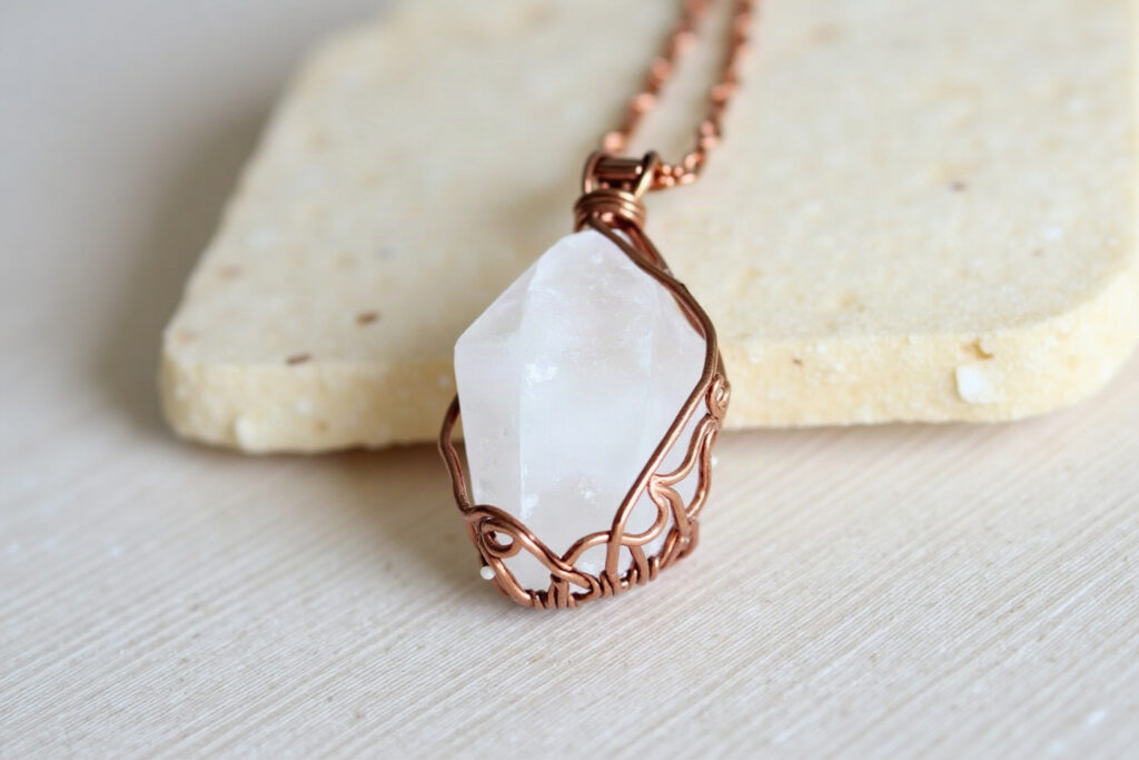 Raw quartz crystal necklace wrapped in copper wire